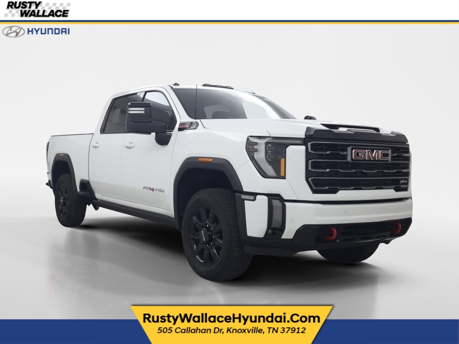 2024 GMC Sierra AT4 in Summit White — front three-quarter view